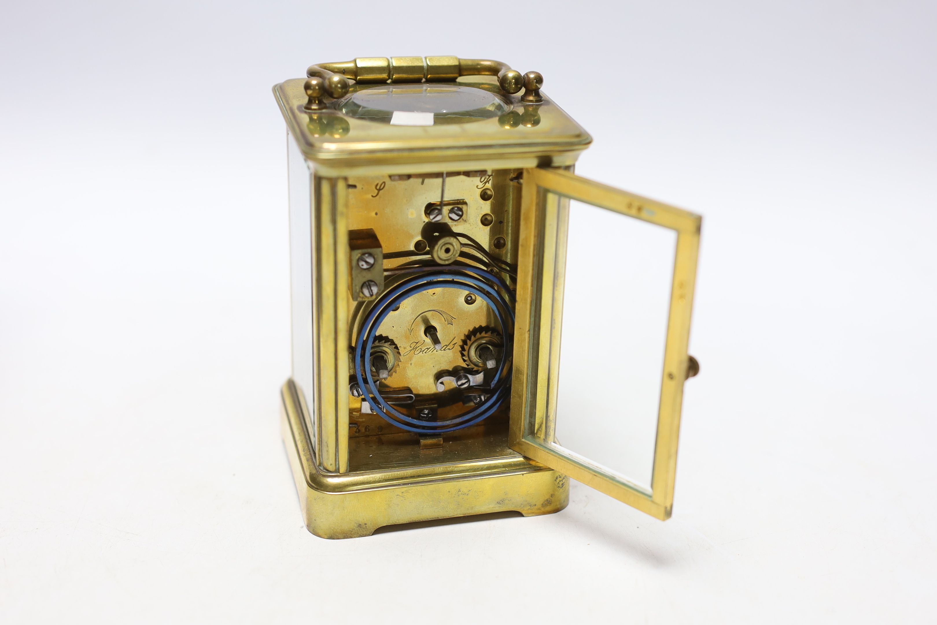 A Curtis brass carriage timepiece, in leather case, 15cm high